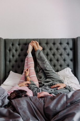 A couple lying on a bed.