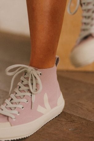 A woman wearing sustainable sneakers from Veja.