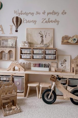 A pink and rustic baby nursery with wooden baby toys in it.