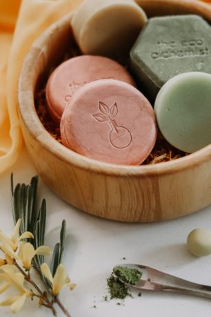 A wooded bowl with palm oil free shampoo bars.